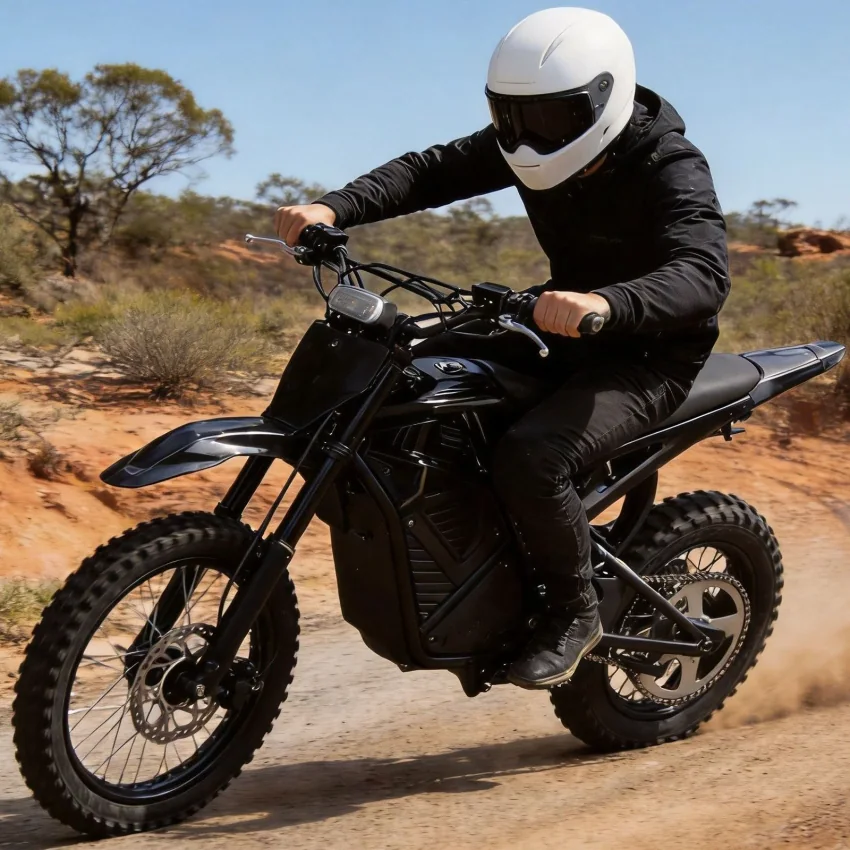 Black Ridge electric dirt bike and rider on a dirt surface